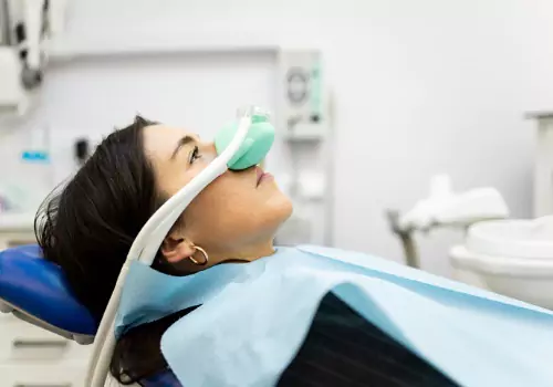 A woman receiving sedation through her nose, during Sedation Dentistry in Galesburg IL