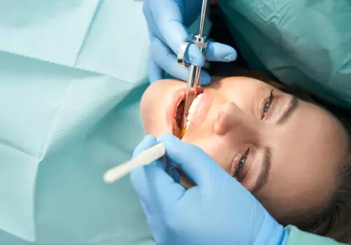 A woman with a dentist inspecting her teeth during Sedation Dentistry in Peoria IL