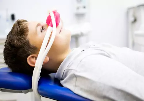 A child receiving conscious inhalation sedation as a part of Sedation Dentistry in Bloomington IL