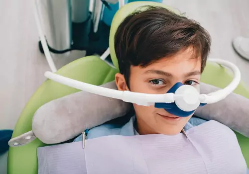 A young boy receiving sedation through his nose during Sedation Dentistry in Washington IL