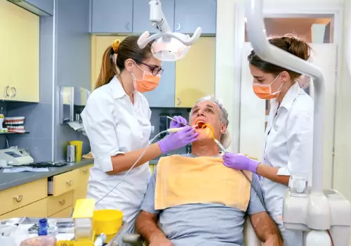 A man having his teeth cleaned after receiving sedation, part of Sedation Dentistry in Washington IL