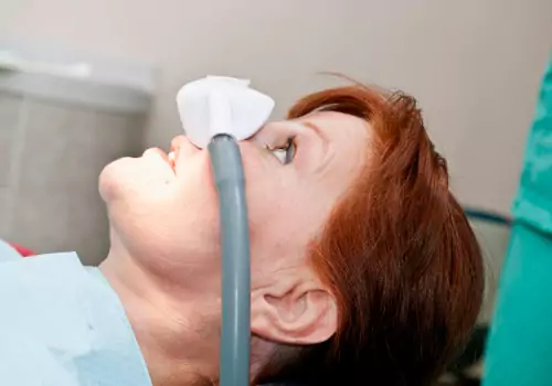 A woman receiving inhalation conscious sedation as a part of Sedation Dentistry in Pekin IL