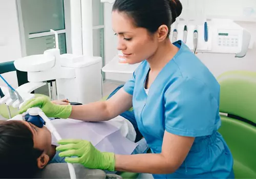 A dental assistant administering sedation to a young patient during Sedation Dentistry in Tremont IL