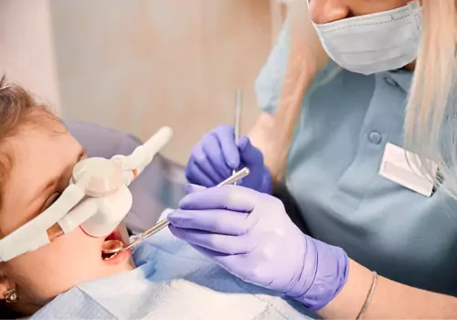 A young boy receiving sedation via his nose during Sedation Dentistry in East Peoria IL