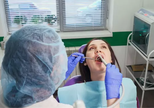 A woman having her teeth worked on without inducing anxiety, thanks to Sedation Dentistry in Bloomington IL