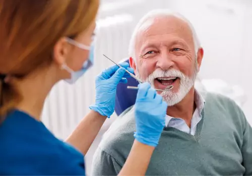 A happy man receiving dental work from a local Dentist in Peoria IL