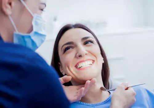 A happy patient smiling at her Dentist in Peoria IL