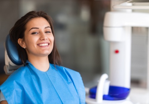 A woman smiles after getting Teeth Whitening in Pekin IL from Total Dental Care