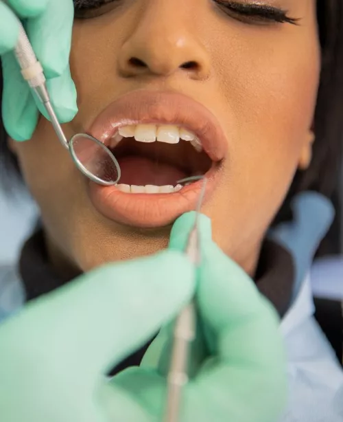 A young woman gets a dental checkup from Total Dental Care, which offers dental services for Central Illinois