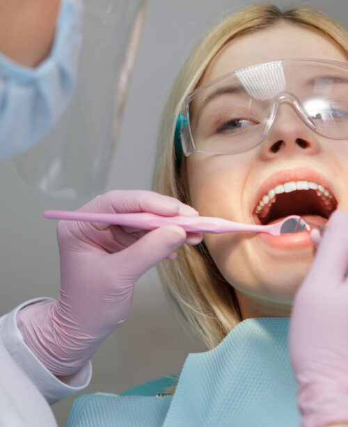 A close-up of a woman having dental treatment performed by Total Dental Care, which offers restorative dentistry and more